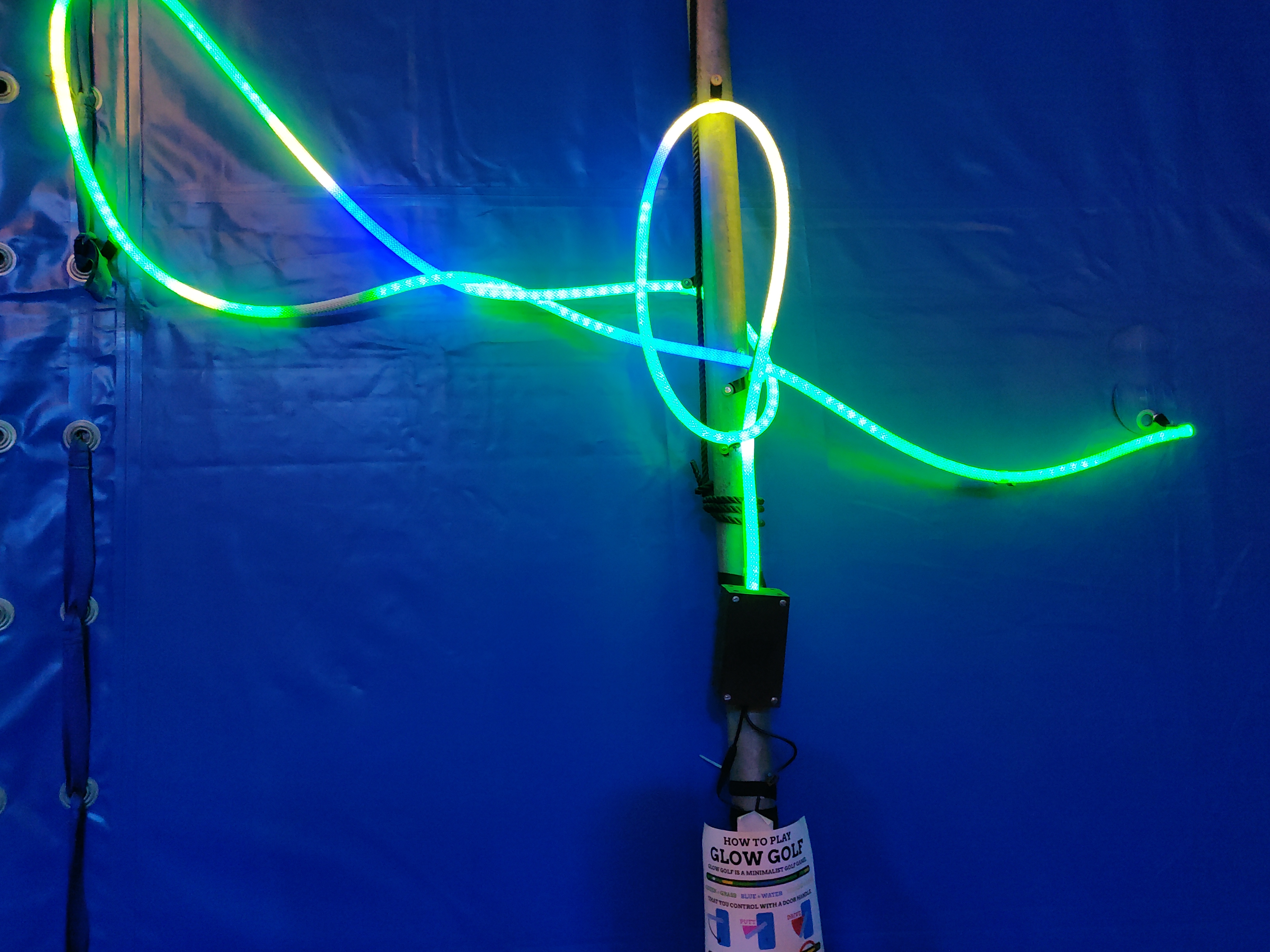 A LED rope with a sign for Glow Golf