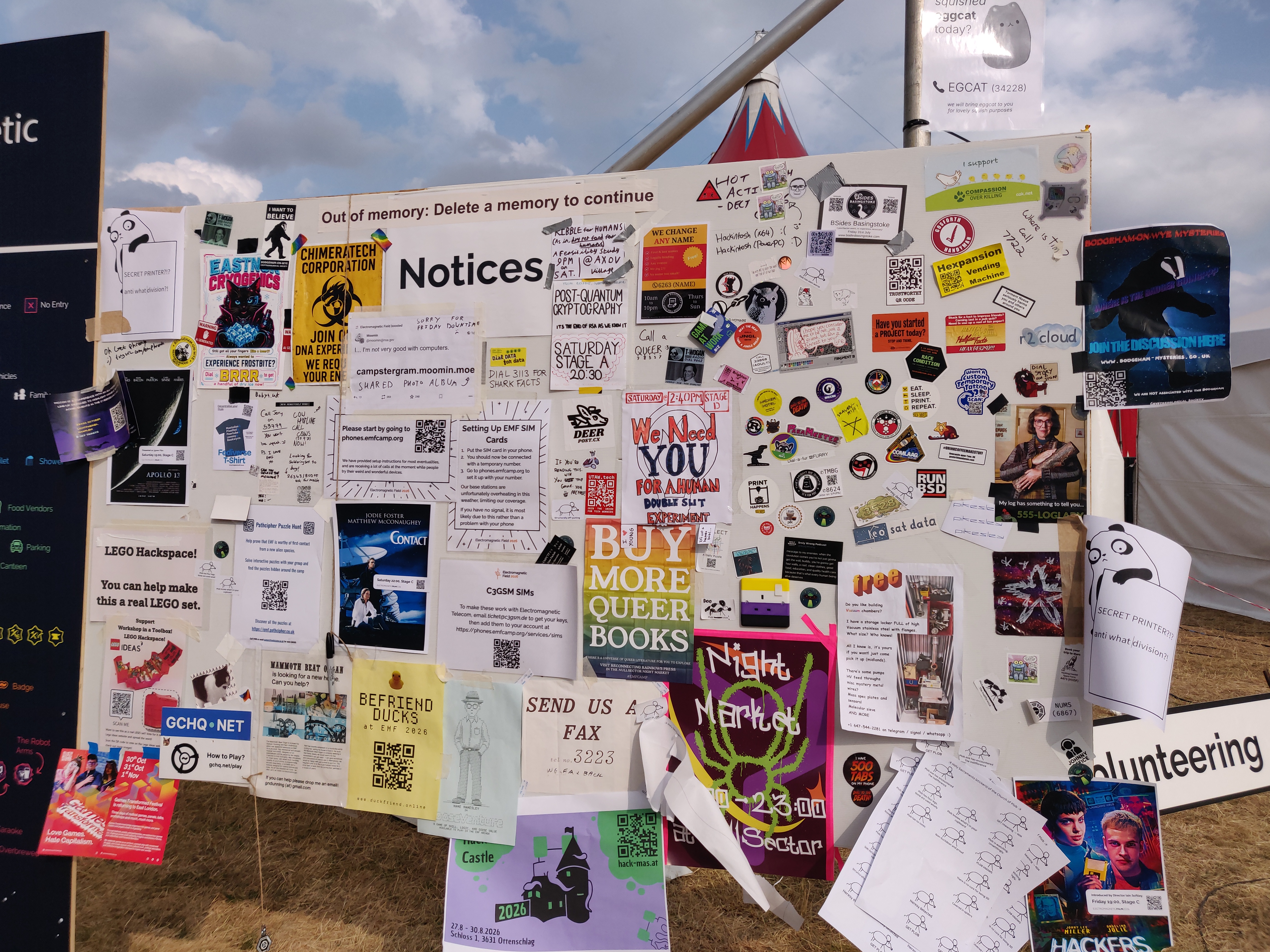 The EMF noticeboard, covered in papers.